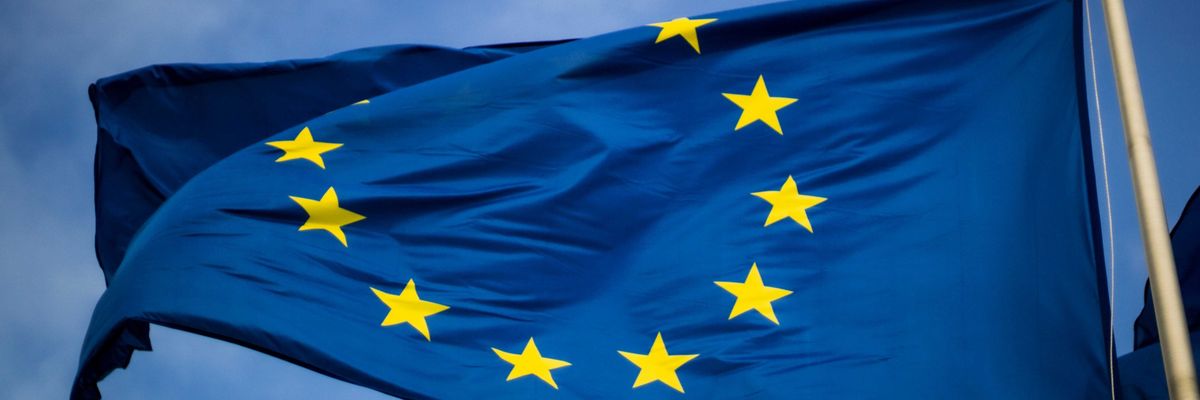 European union flag blue with yellow stars in a circle.