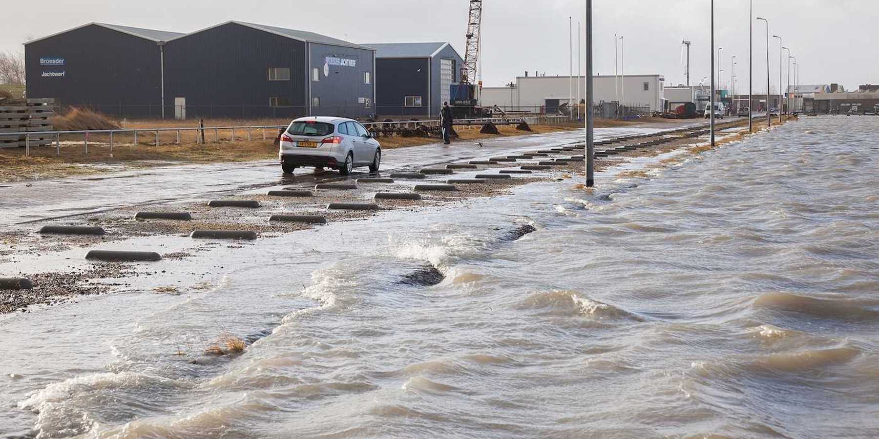 Extreme high tide and flooded roadway at the dikes of the Dutch coastal works