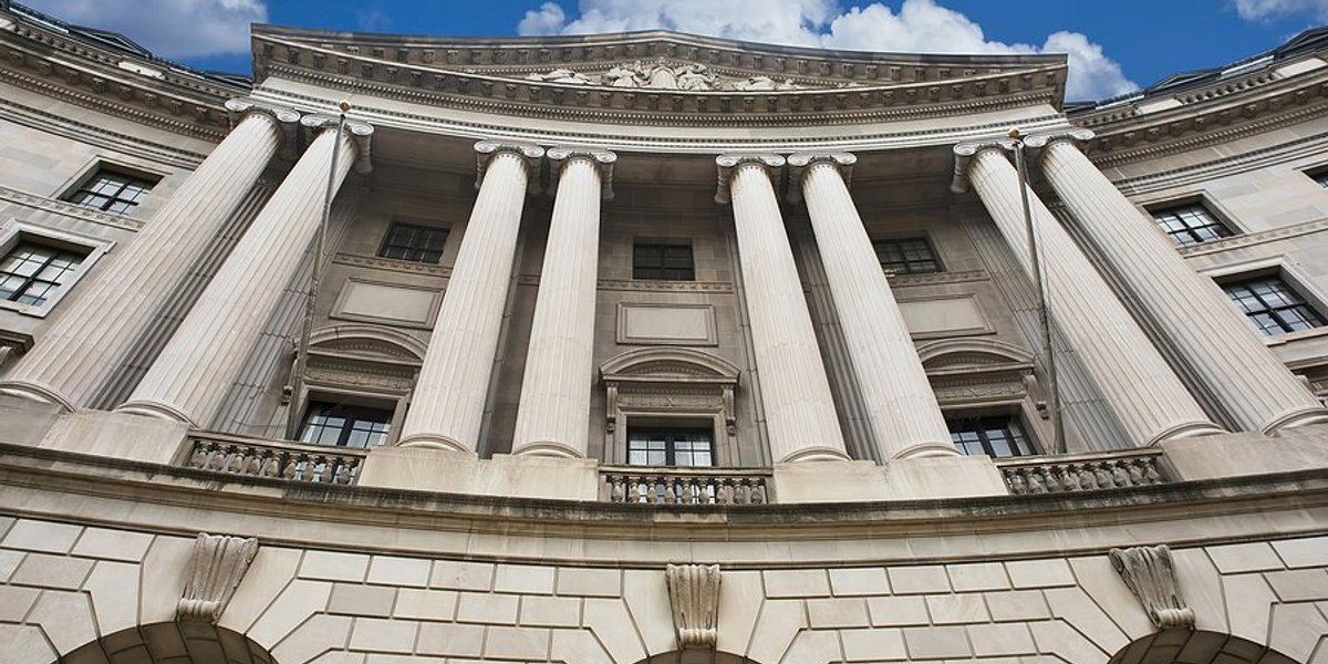 Facade of the Environmental Protection Agency with blue sky and clouds behind.