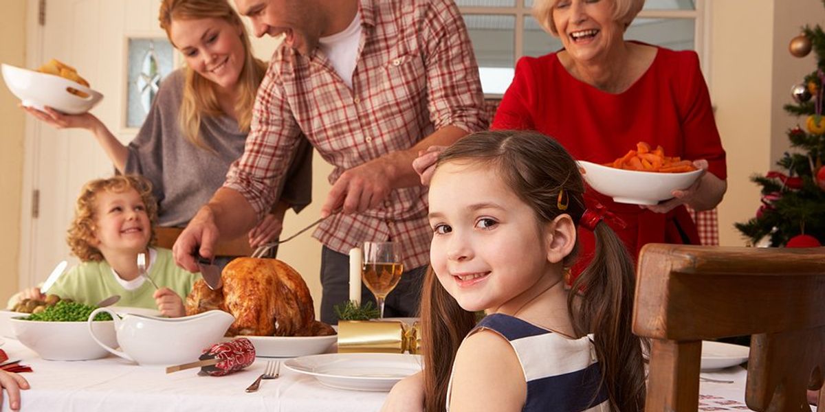 Family gathered around the table at Christmas.