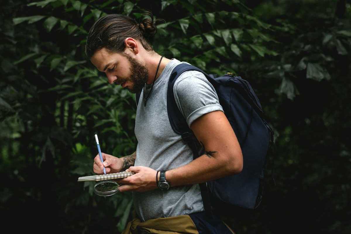 Field scientist recording notes in notebook