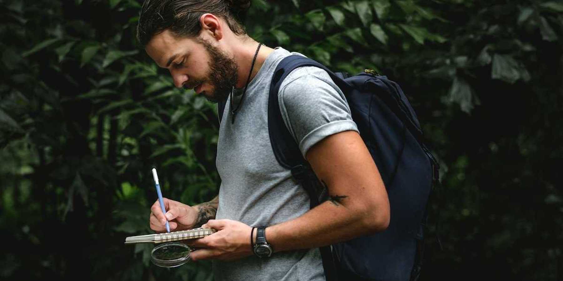 Field scientist recording notes in notebook