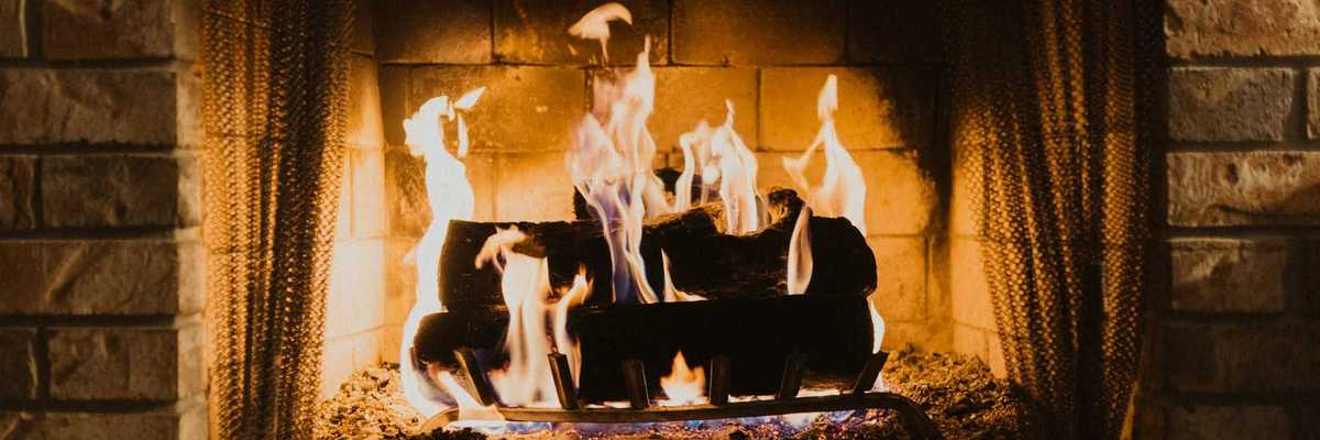 Firewood burning in an indoor fireplace