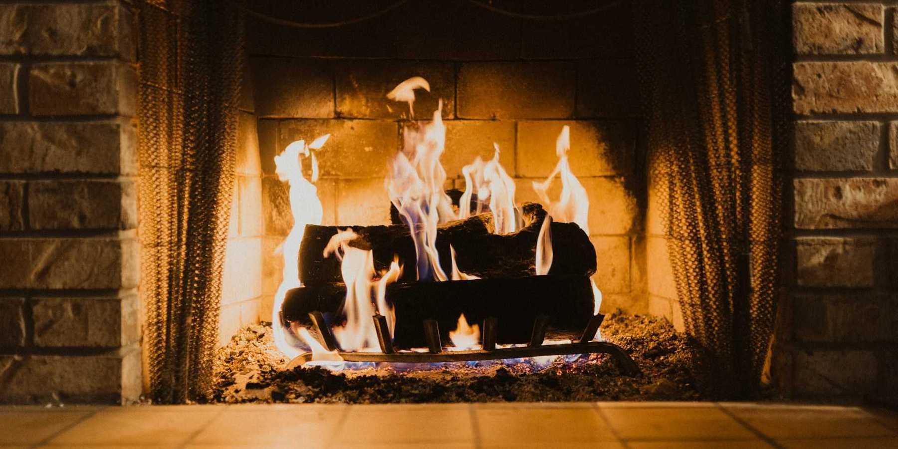 Firewood burning in an indoor fireplace