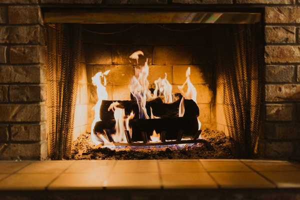Firewood burning in an indoor fireplace