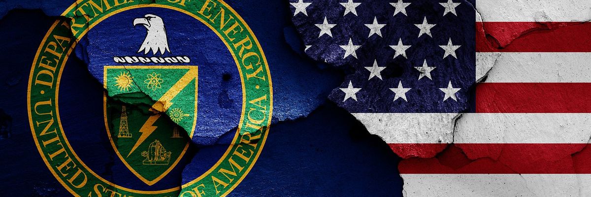 flags of Department of Energy and USA painted on cracked wall