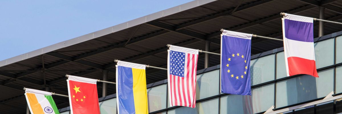 Flags of various nations fly on building