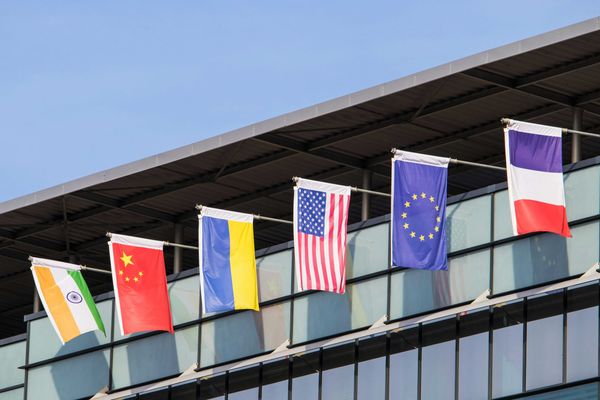 Flags of various nations fly on building