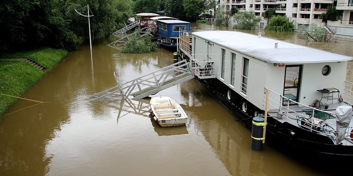 Flood waters rising next to house boats.