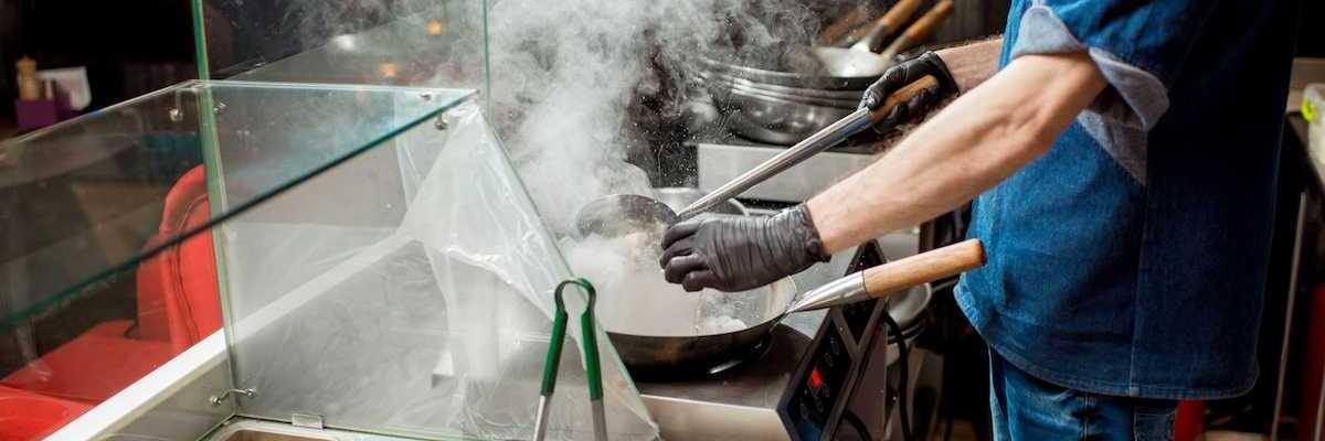 Food service line worker in a hot kitchen