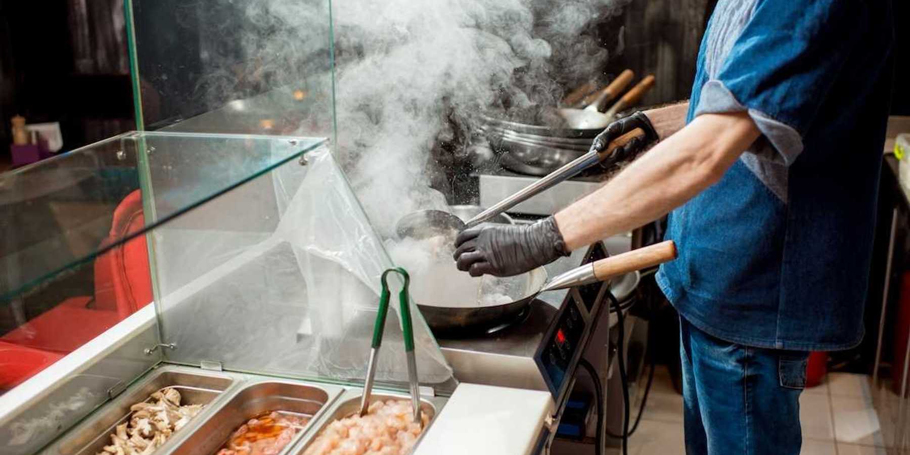 Food service line worker in a hot kitchen