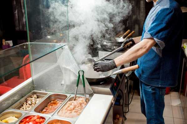 Food service line worker in a hot kitchen