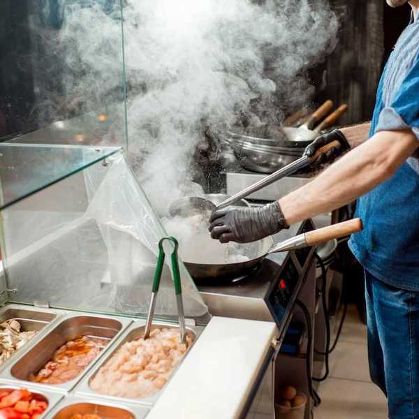 Food service line worker in a hot kitchen