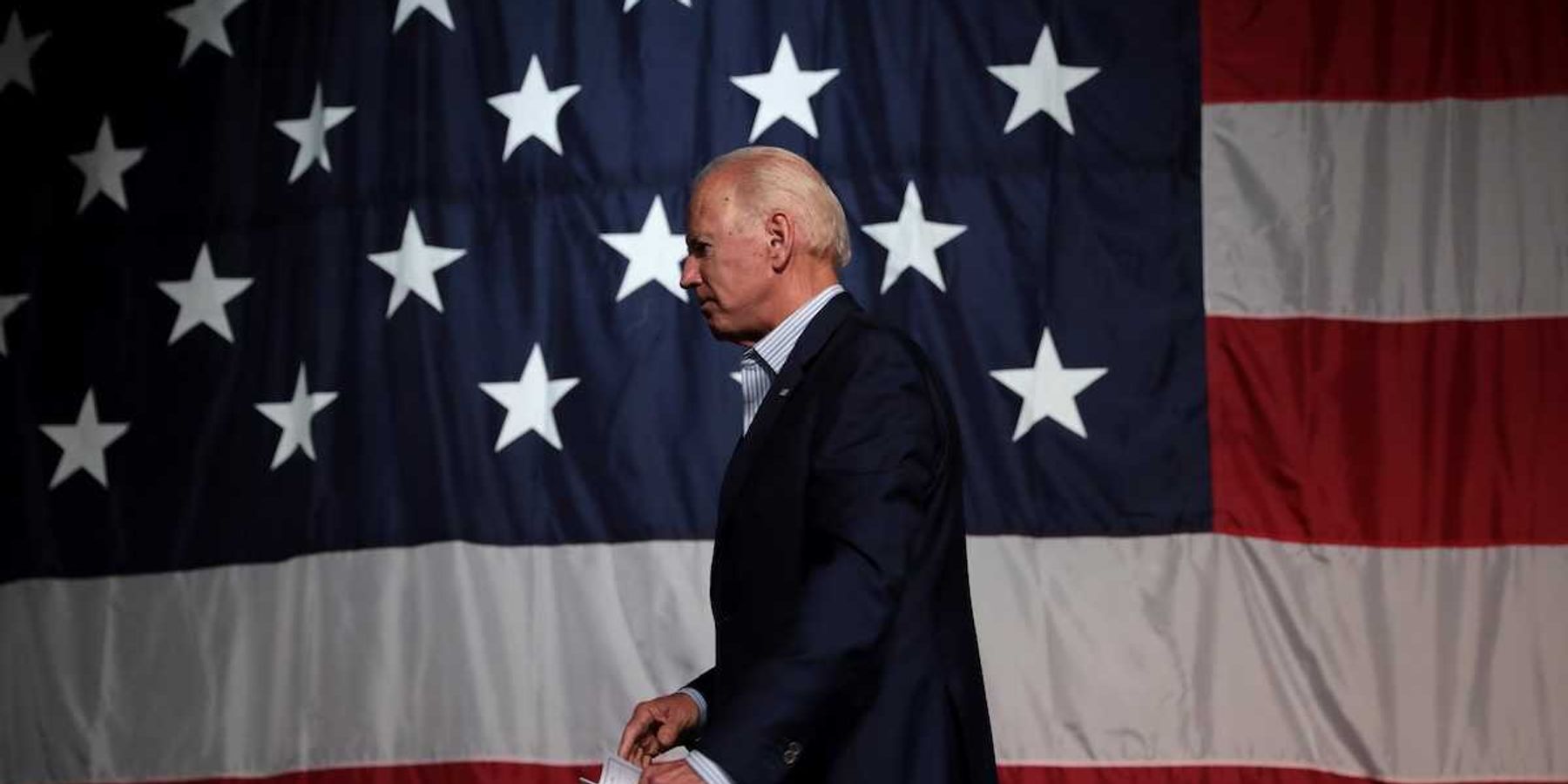 Former President of the United States Joe Biden with American flag backdrop