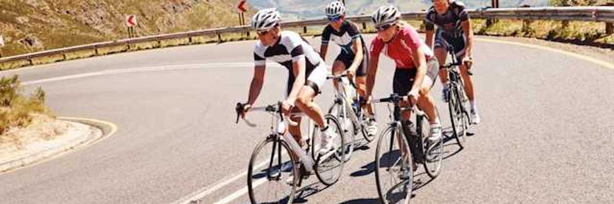 Four cyclists on a curvy mountain road