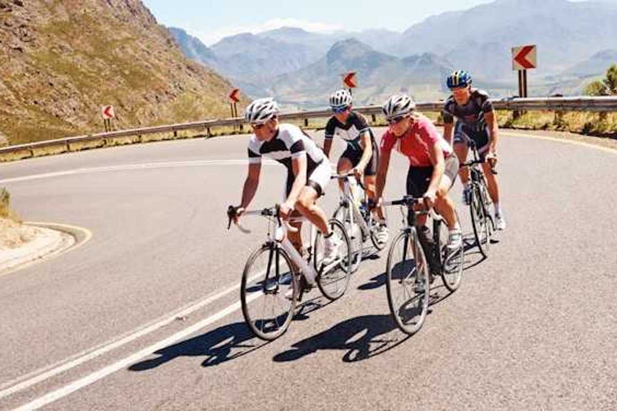 Four cyclists on a curvy mountain road