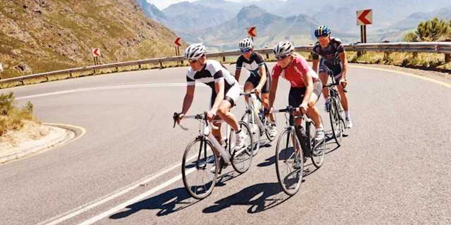 Four cyclists on a curvy mountain road