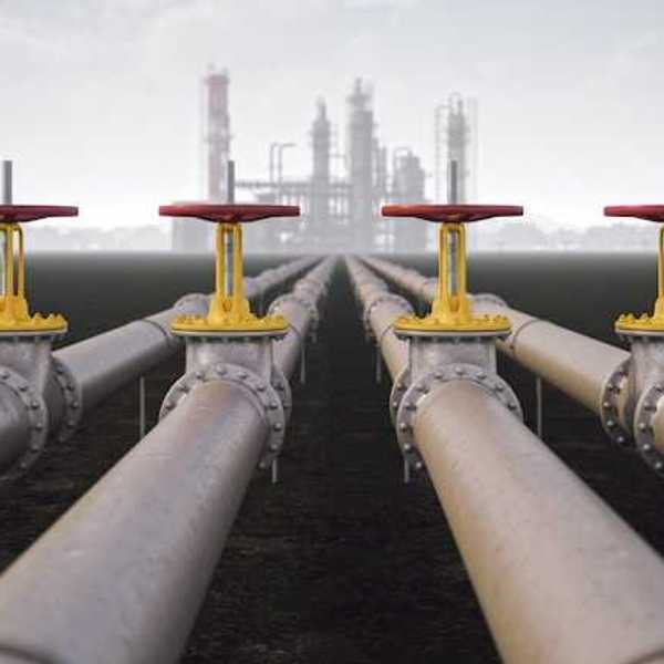 Four gas pipelines stretching toward a gas facility