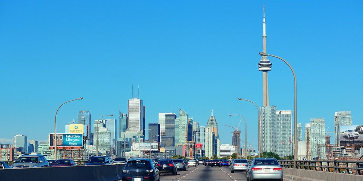 Freeway entering Toronto Ontario Canada with city skyline in the background.