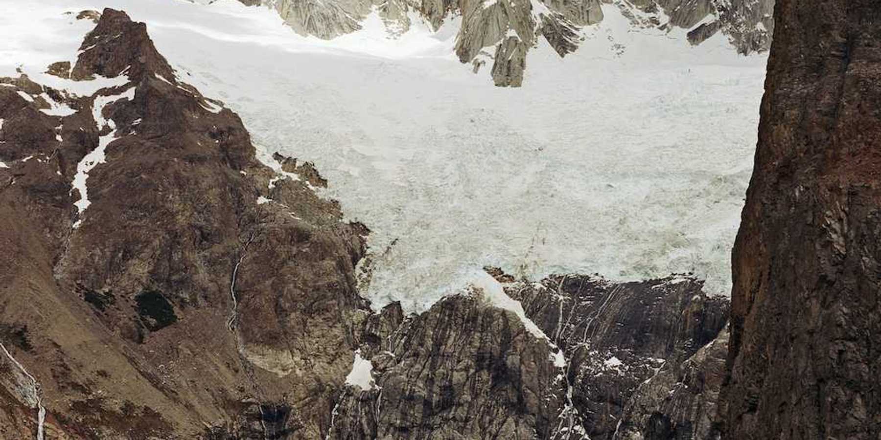Glaciers hanging over an alpine lake formed by glacial meltwater