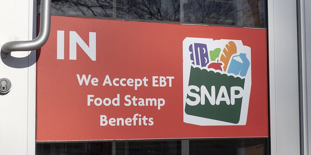 Glass door with a sign indicating that they accept SNAP food stamp cards.