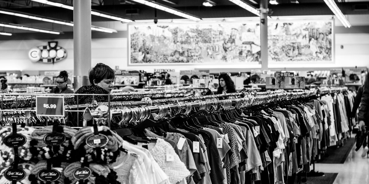 grayscale photography of people inside a clothing shop.