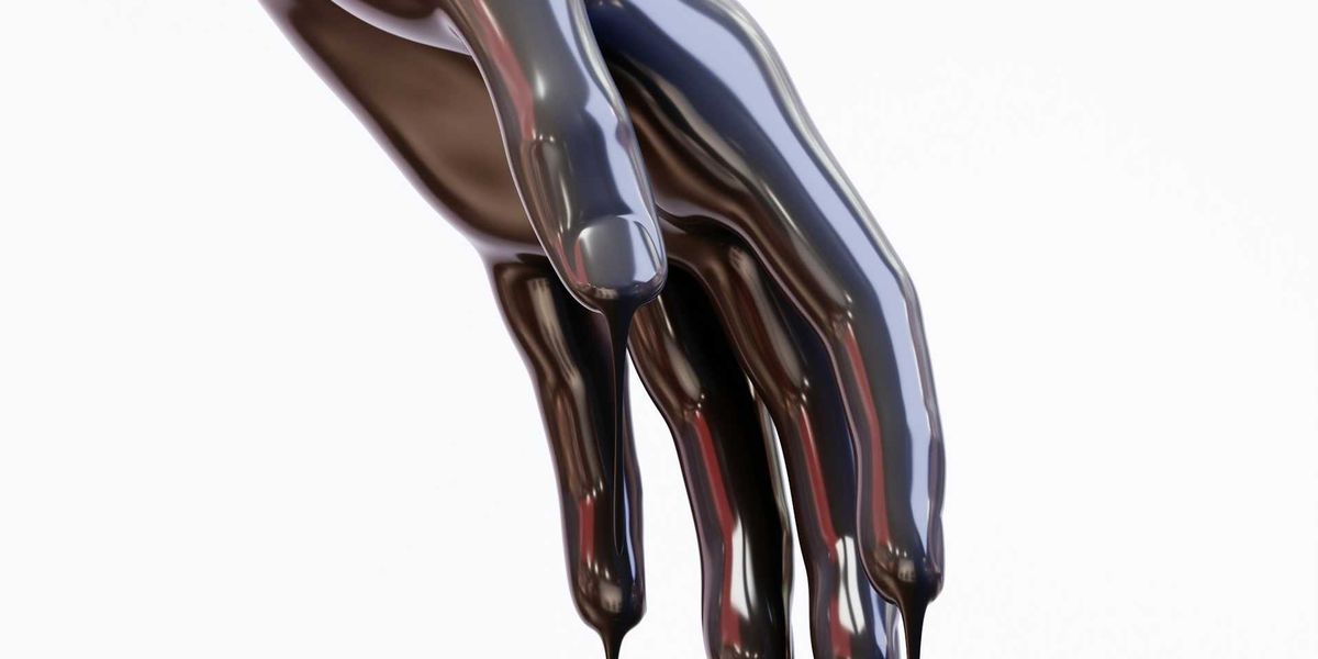 Hand covered in and dripping oil