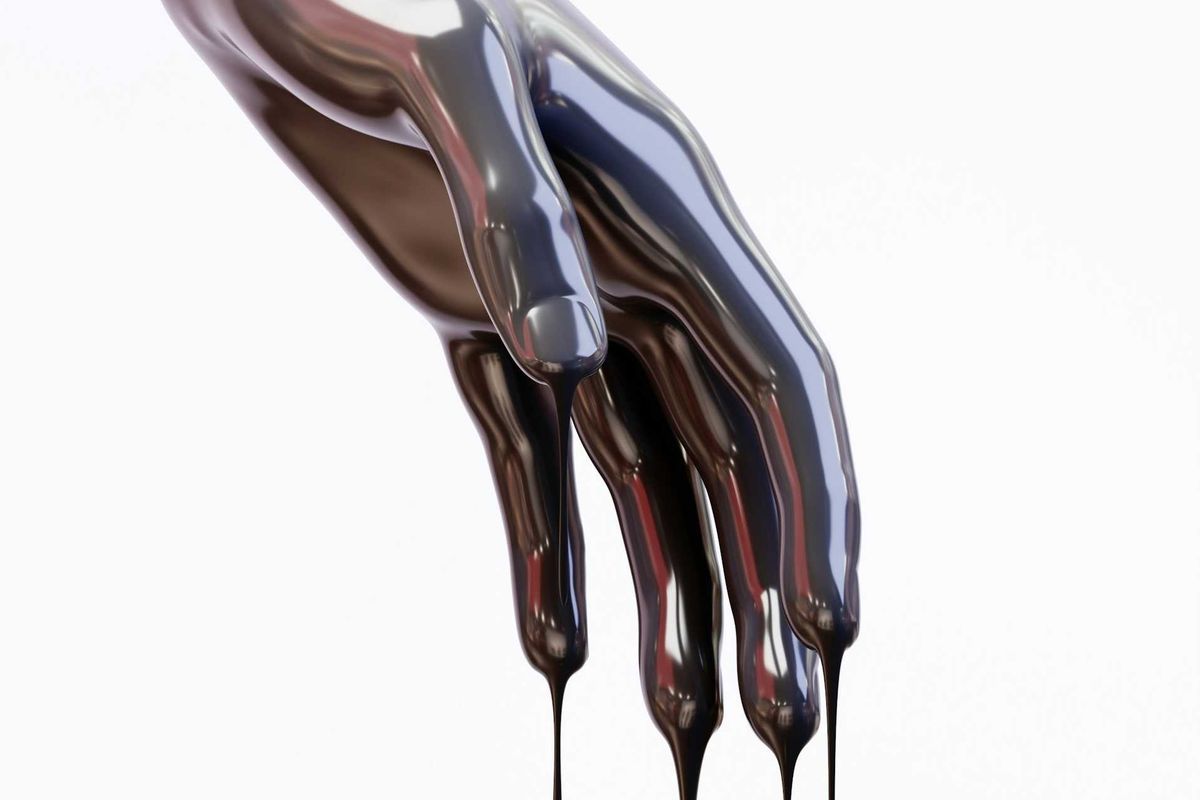 Hand covered in and dripping oil