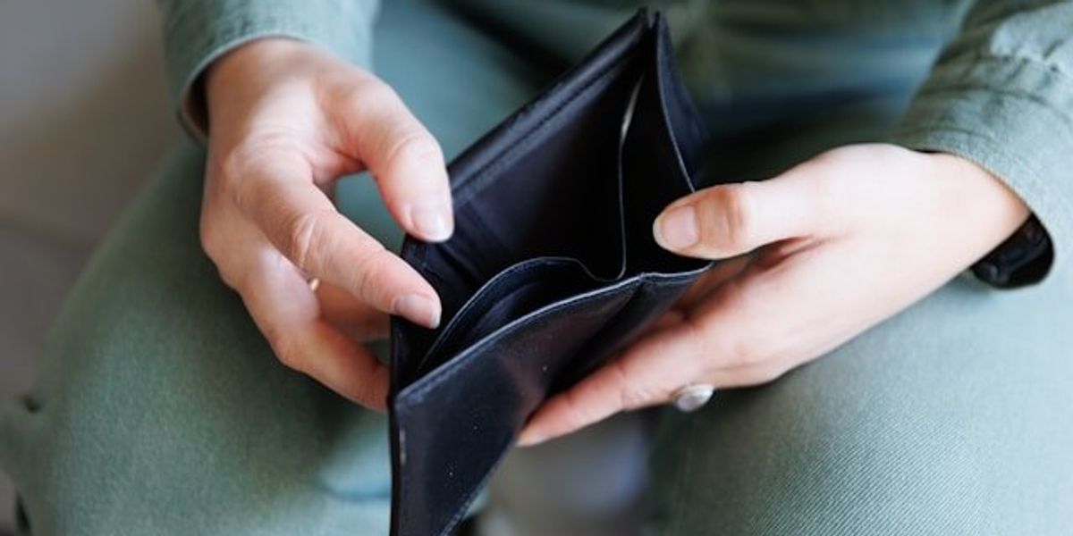 Hands holding an empty wallet.