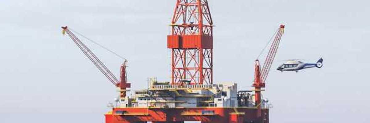 Helicopter landing on helipad at an offshore oil rig