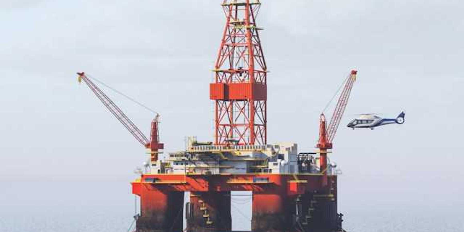 Helicopter landing on helipad at an offshore oil rig
