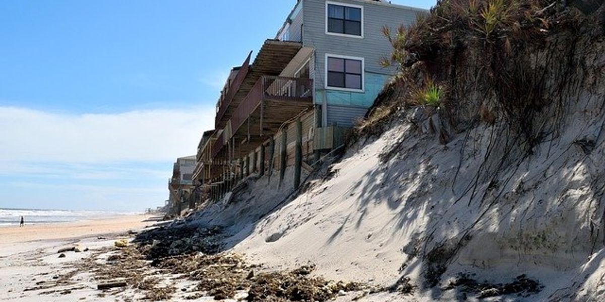 Homes in Florida perched on the edge of a beach dune eroded by a hurricane.