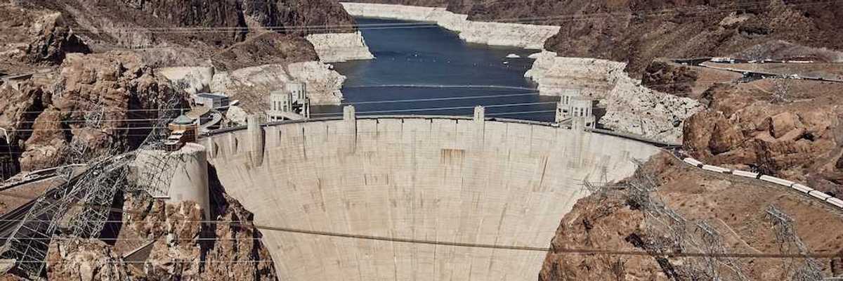 Hover Dam with Lake Mead and the Colorado River behind showing the "bathtub ring."