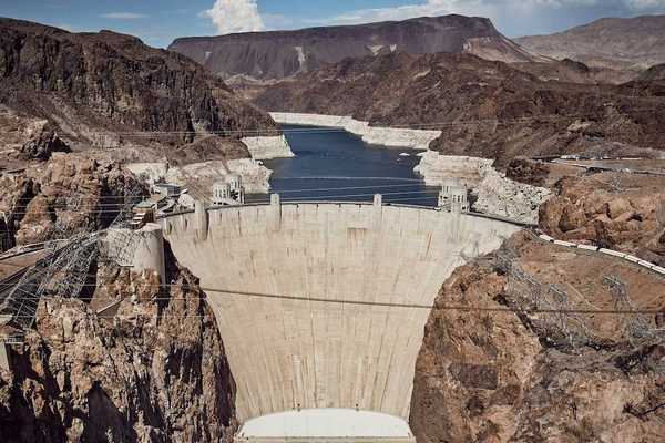 Hover Dam with Lake Mead and the Colorado River behind showing the "bathtub ring."