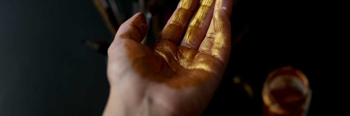 Human palm of hand coated with gold