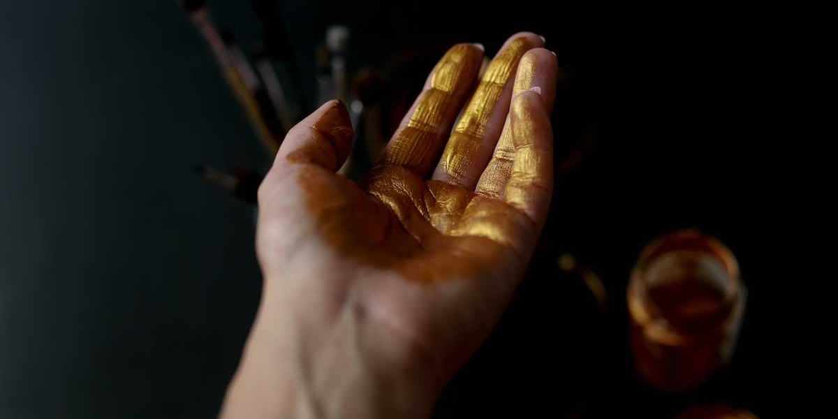 Human palm of hand coated with gold