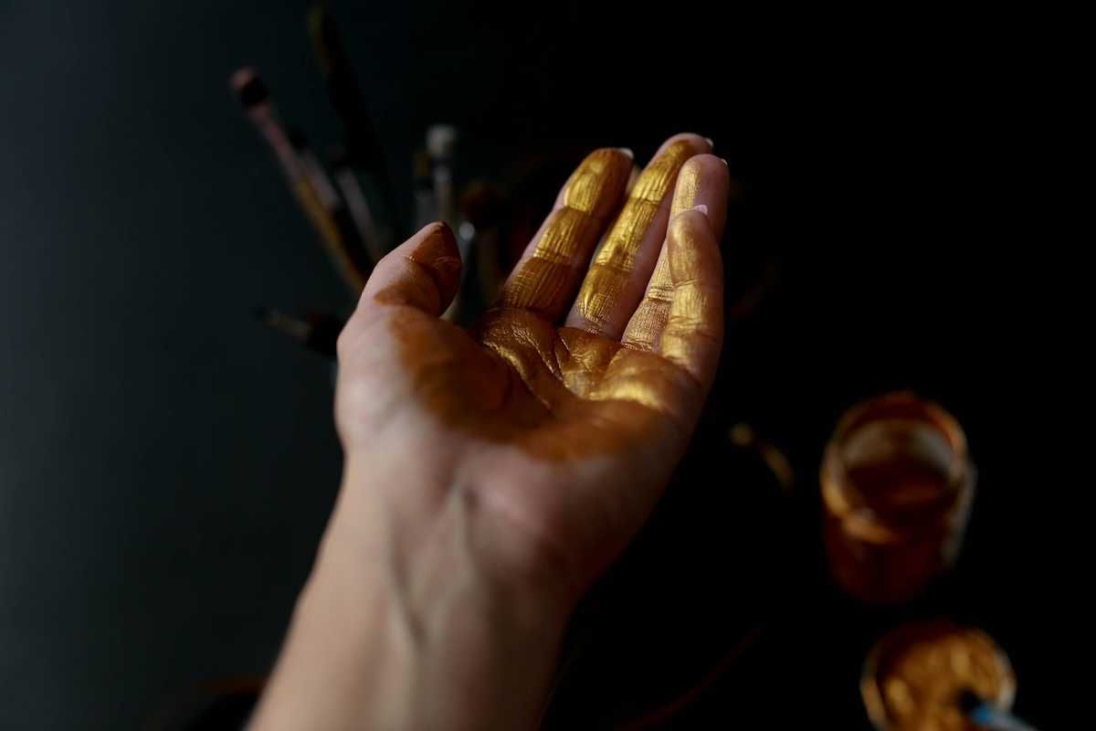 Human palm of hand coated with gold
