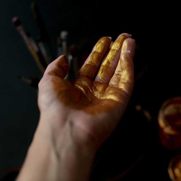 Human palm of hand coated with gold
