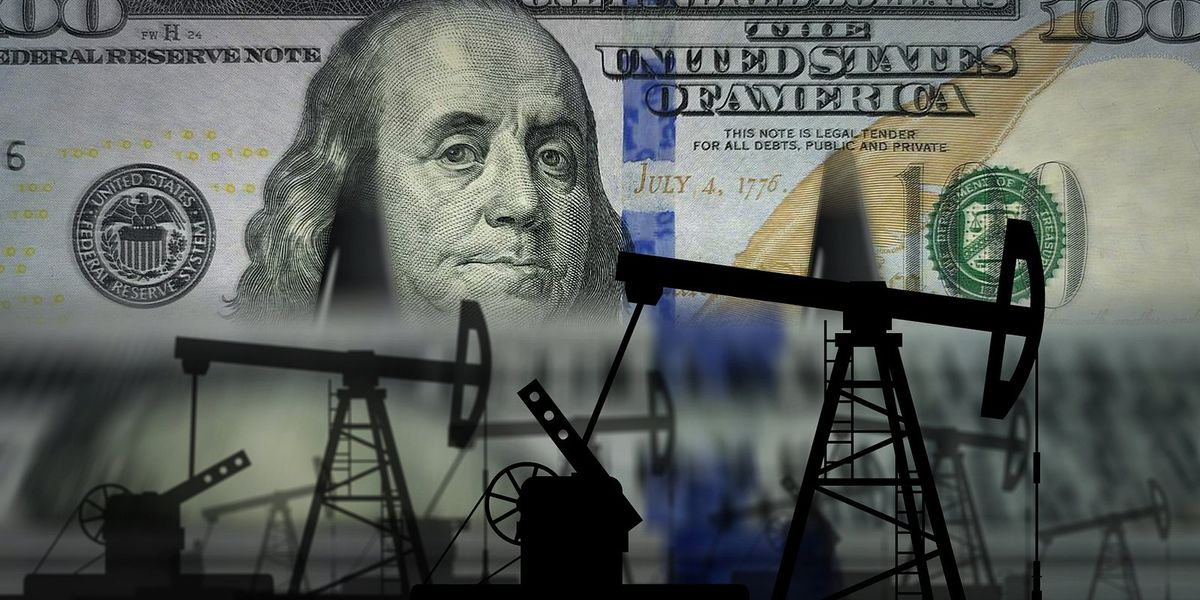 Hundred dollar bill in background with fossil fuel infrastructure shadows in front of it