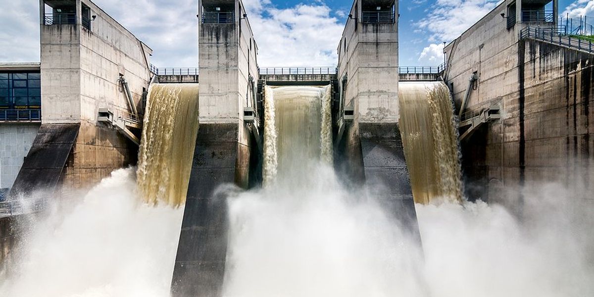 Hydroelectric dam with water rushing beside concrete columns