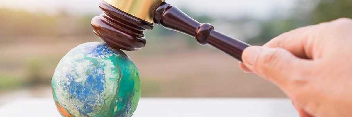 Illustration of judges gavel poised to strike planet model