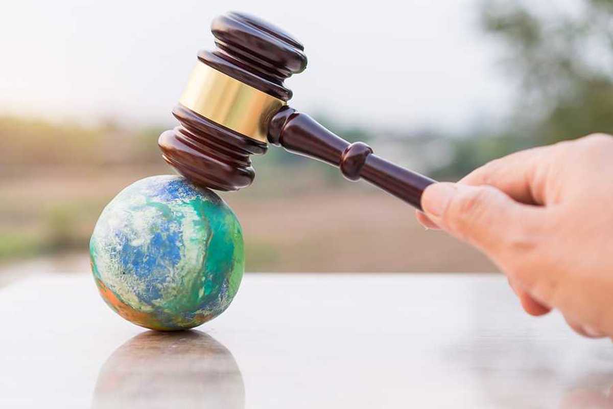Illustration of judges gavel poised to strike planet model