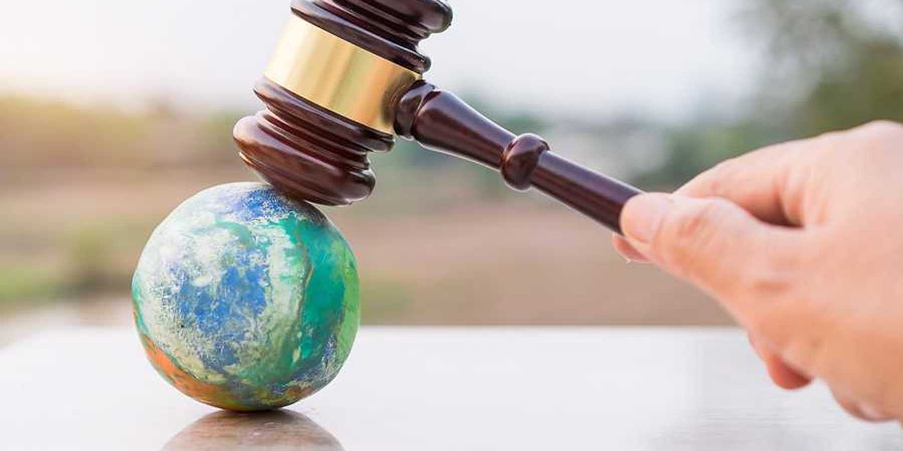 Illustration of judges gavel poised to strike planet model