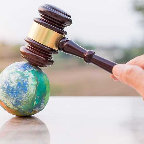 Illustration of judges gavel poised to strike planet model
