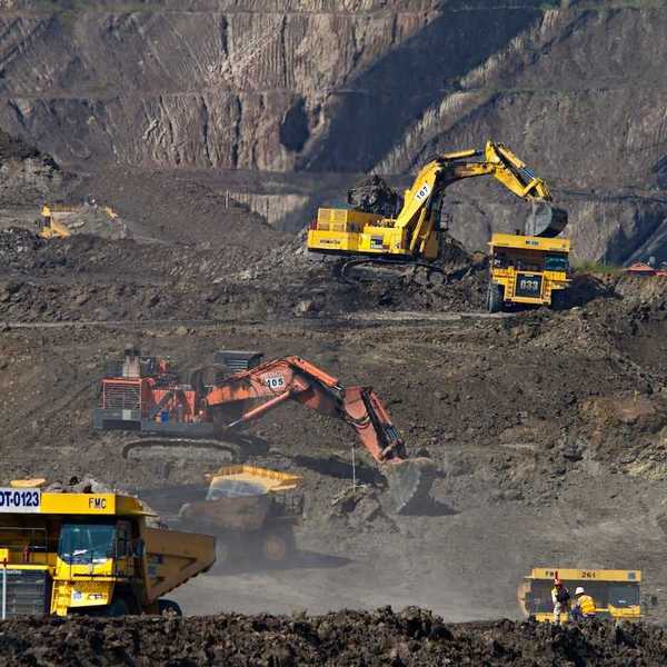 Indonesian coal mining operation featuring multiple excavators and rock trucks