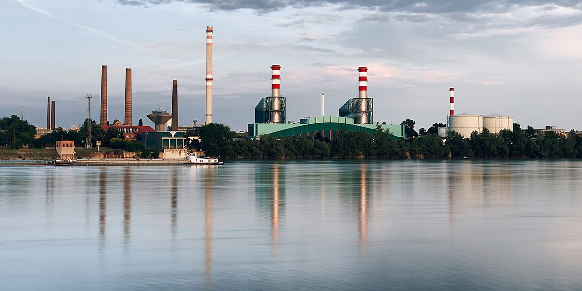 industrial buildings across a broad river.