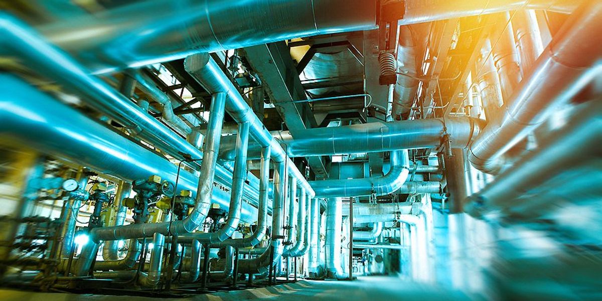 Interior of a factory with pipes and equipment.