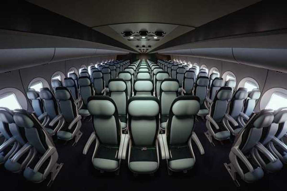 Interior of an airplane with seats stretching into the distance