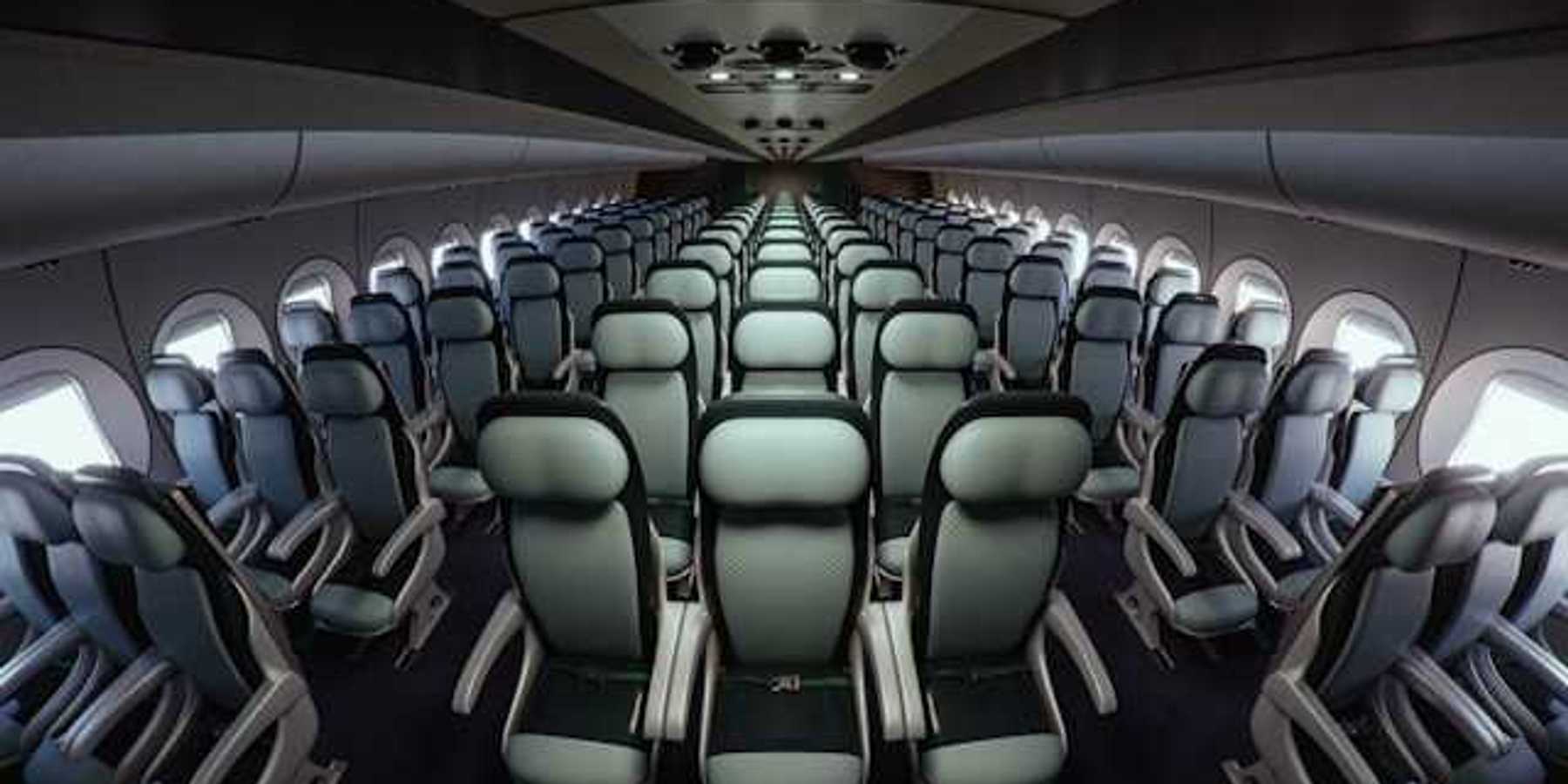Interior of an airplane with seats stretching into the distance