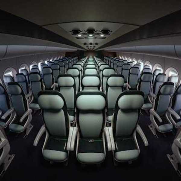 Interior of an airplane with seats stretching into the distance